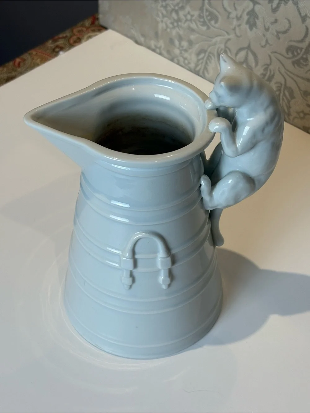 Vintage White Porcelain pitcher with a cat as a handle. Holds 20oz.